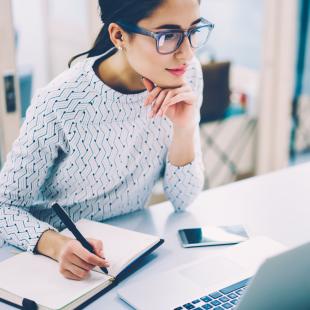 Woman works at laptop