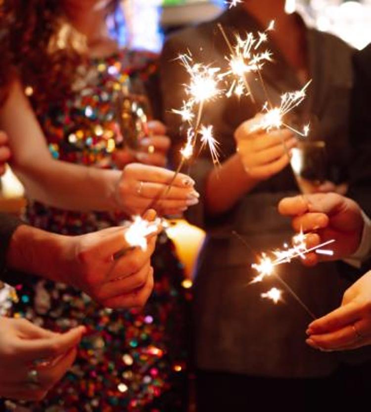 People holding sparklers and champange.