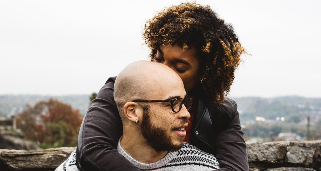 a young couple holds each other outside in the cold