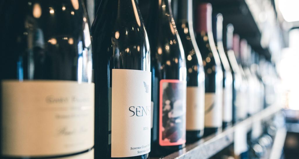 a closeup shot of various wine bottles in a wine cellar