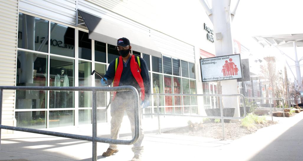 Worker cleans handrails at Nebraska Crossings