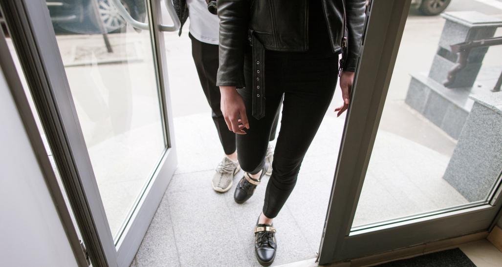 Two customers entering a store