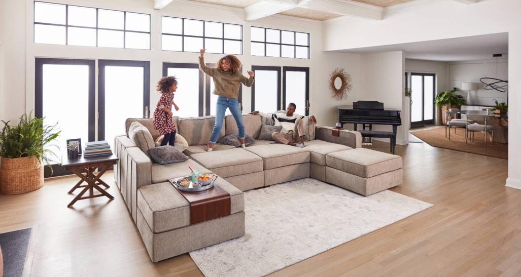 Family jumps on a Lovesac sofa