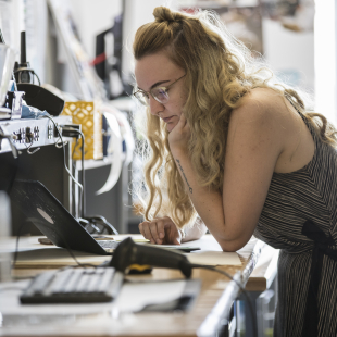 Designer at a fashion brand working on a computer