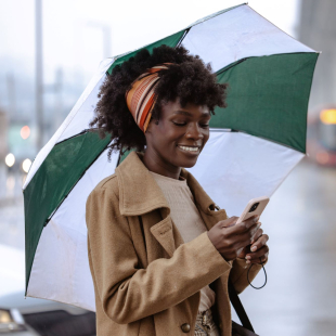 Woman on her phone in the rain. 